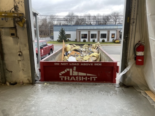 warehouse demolition debris in a dumpster from trash it disposal
